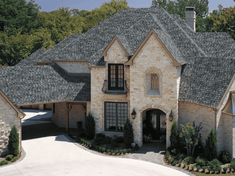 Luxury home with newly installed dark gray asphalt shingle roof